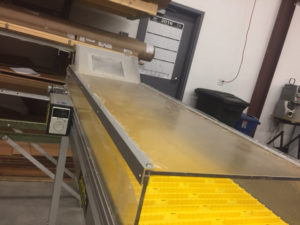 Gradient cooler enclosed hood conveyor