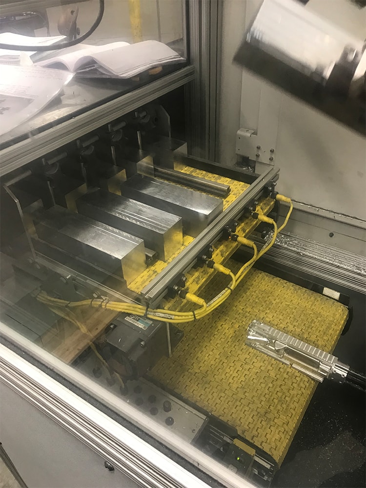 machined parts over under conveyor