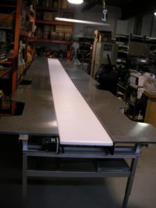 long-line work station conveyor with cut-outs